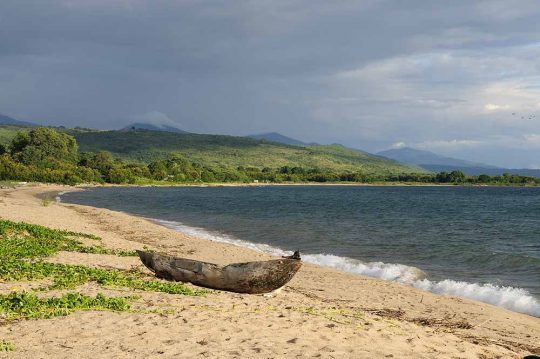Tanzania, Malawi lake is the Worlds longest and second deepest fresh water lake, it is also one of the oldest lakes on the planet. The picture presents beautiful sand beach and traditional dugout canoe